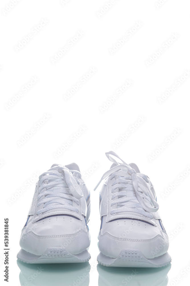 Pair of of New White Sneakers Placed Against White Background. Pair of of New White Sneakers Placed Against White Background.