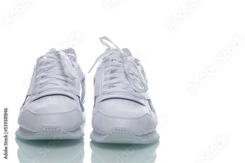 Pair of of New White Sneakers Placed Against White Background.