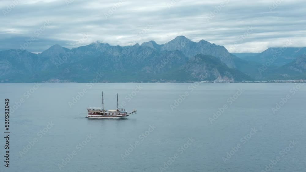 Sea boat trip. Tourist excursion ship at sea against the backdrop of beautiful mountains. Sea boat trip. Tourist excursion ship at sea against the backdrop of beautiful mountains.