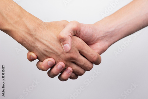 strong male handshake with bare hands on a white background