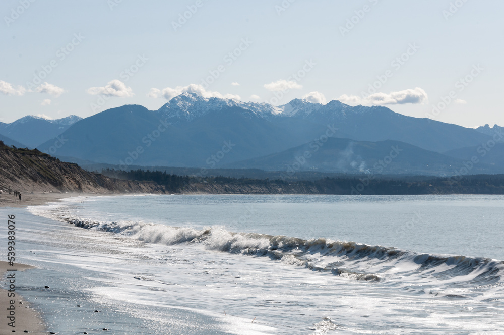 Surf waves at mountain background at Dungeness Spit, Olympic Peninsula, USA