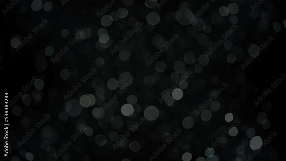 White bokeh dust particles floating in the air. Slow motion. White bokeh dust particles floating in the air. Slow motion.
