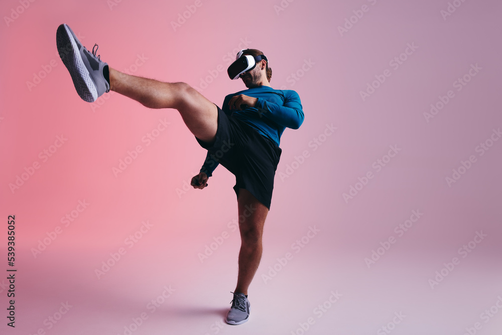 Gamer throwing a kick in virtual reality. Man playing a vr game in a