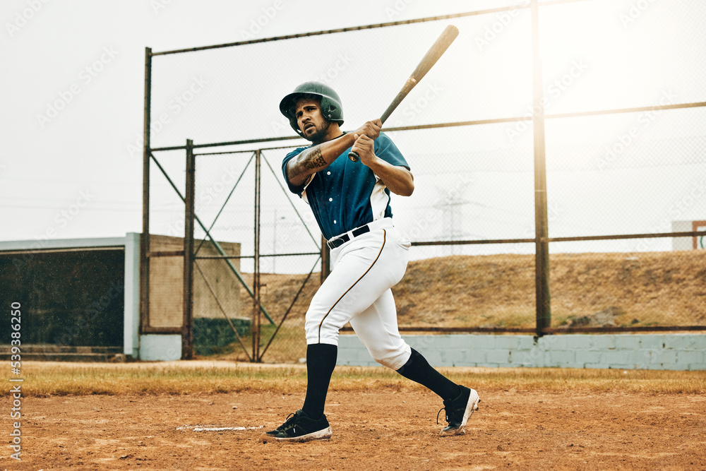 Baseball man, stadium game or hit ball with bat on a sport field in a game. Sports player with practice, strike and concentration to win match by competitive male batter focus during training outdoor Baseball man, stadium game or hit ball with bat on a sport field in a game. Sports player with practice, strike and concentration to win match by competitive male batter focus during training outdoor