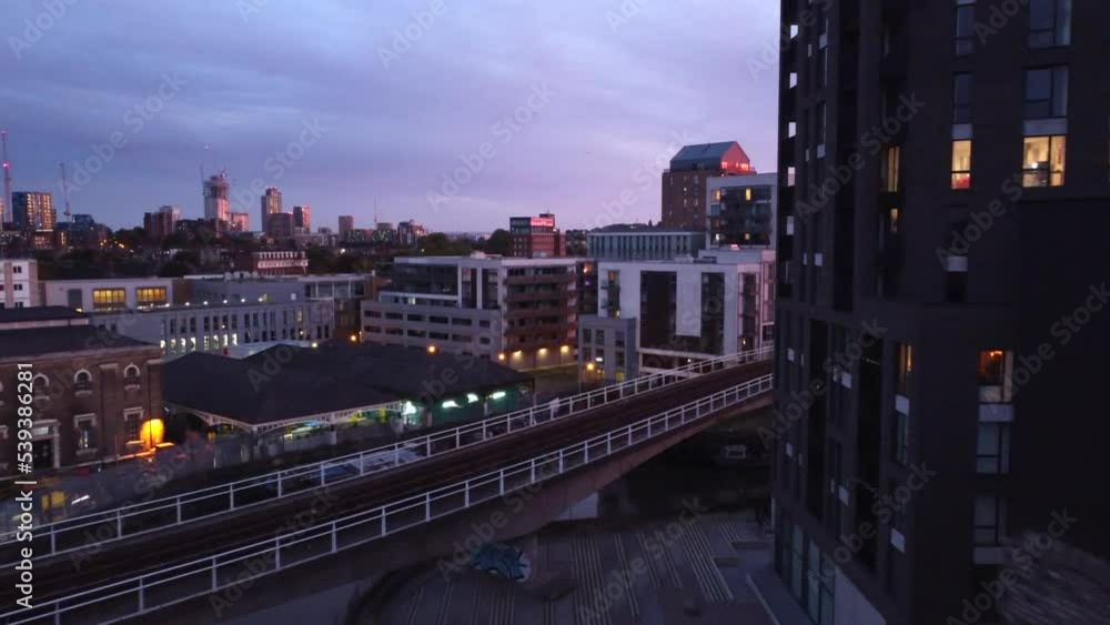 Drone shot flying over buildings in East London at twilight, England