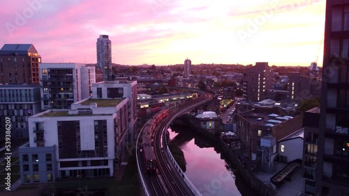 Drone shot overground tube or train on London city skyline at sunset photo