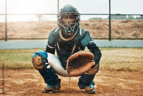 Baseball, catcher and sports with man on field at pitchers plate for games, fitness and health in stadium park. Helmet, glove and uniform with athlete training for workout, achievement and exercise photo