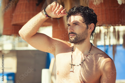 Obraz na plátně Topless young man portrait looking on sun