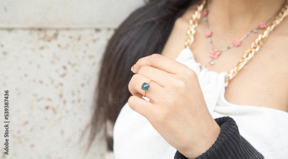 Young woman showing her engagement ring.