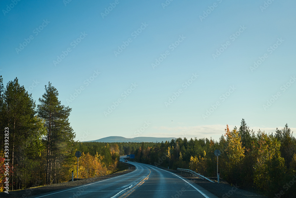 Highway through the autumn forest. Autumn forest highway Highway through the autumn forest. Autumn forest highway