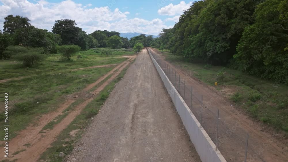 Concrete Barrier Dividing Haiti And The Dominican Republic Under Construction In Dajabon, Dominican Republic. - aerial Concrete Barrier Dividing Haiti And The Dominican Republic Under Construction In Dajabon, Dominican Republic. - aerial