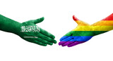 Handshake between LGBT and Saudi Arabia flags painted on hands, isolated transparent image.