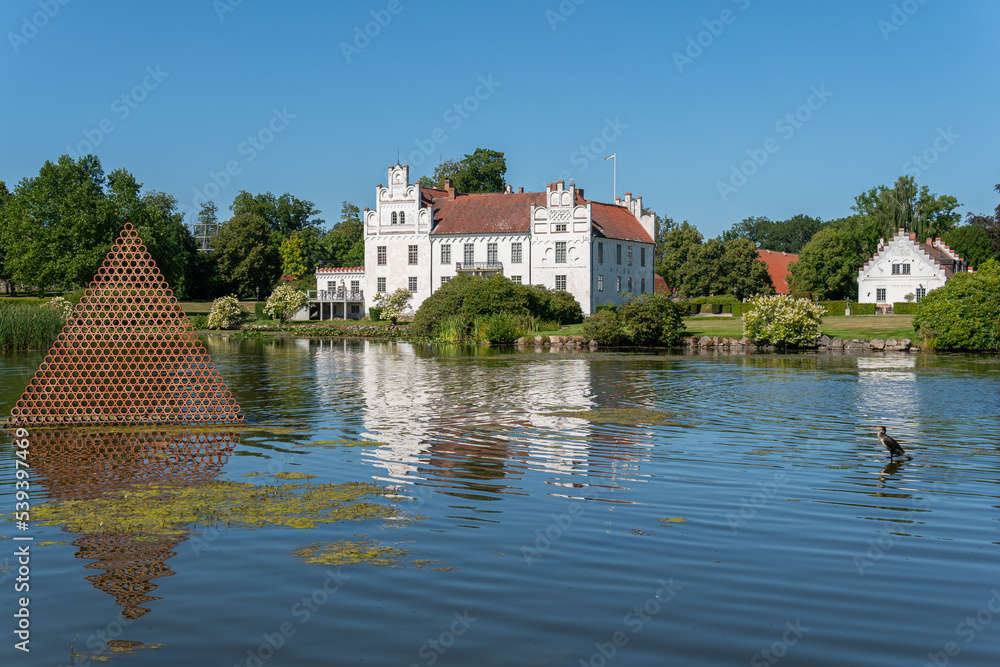 Sweden, Wanas – August 14, 2022: A beautiful ancient castle in front of a lake on a sunny summer day 