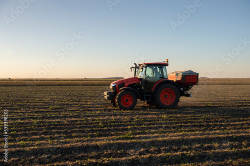 Tractor spreading artificial fertilizers