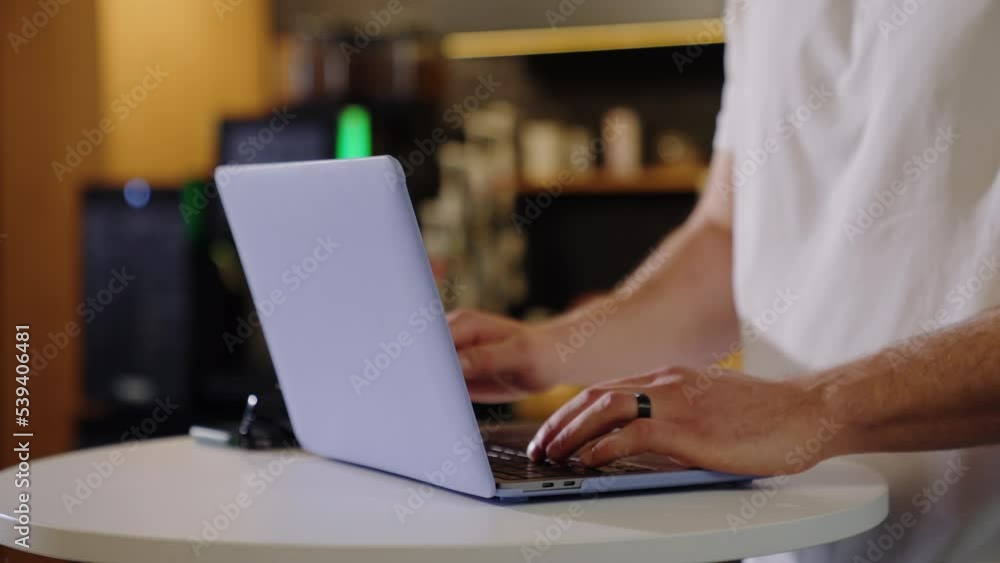 Close-up of the hands of a man who is typing on a laptop in the office Close-up of the hands of a man who is typing on a laptop in the office