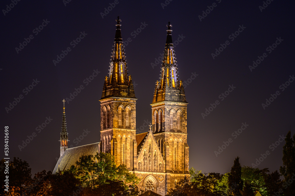 Illuminated Basilica of St. Peter and St. Paul on Vysehrad hill in Prague in strong moonlight.