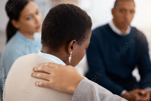 Fototapeta Mental health, support and black woman in a counseling therapy session with a group of people helping with stress