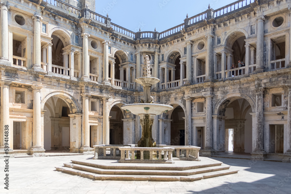 View at the Renaissance main cloister, with ornamented fountain in the middle, an iconic piece of the Portuguese renaissance type, on Convent of Christ, Tomar