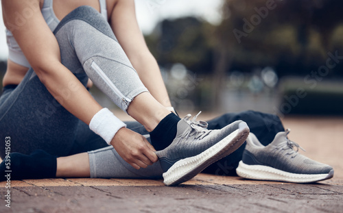 Shoes, fitness and exercise with a sports woman or running getting ready for a workout on the sidewalk outdoor. Training, health and cardio with a female athlete or runner preparing for a routine run
