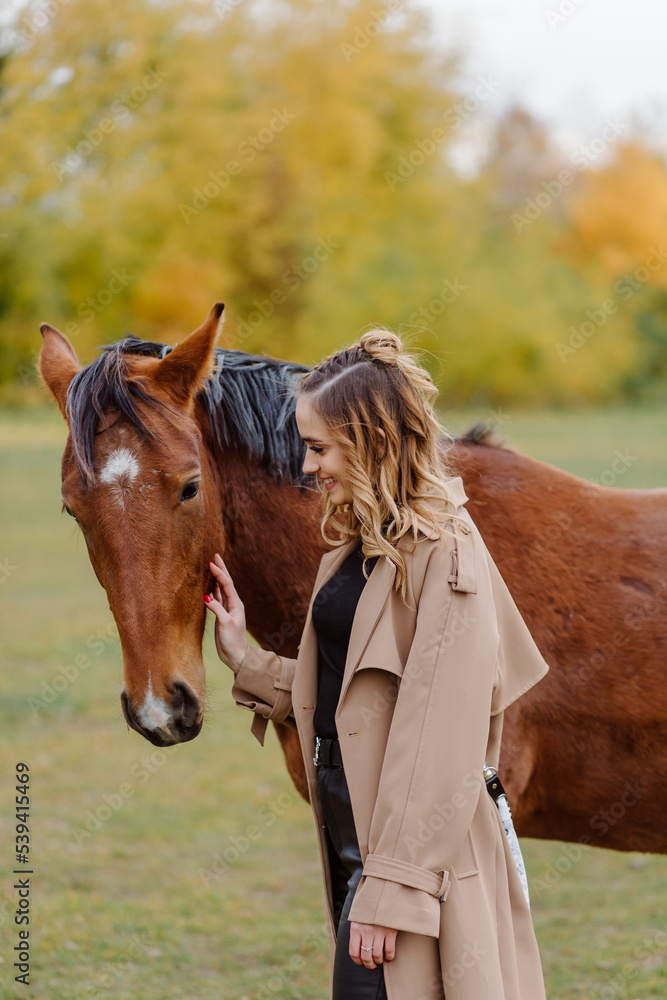 Fototapeta premium Woman on a horse at rancho. Horse riding, hobby time. Concept of animals and human