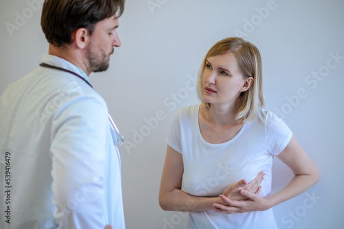 Adult woman discussing her health problems with a doctor