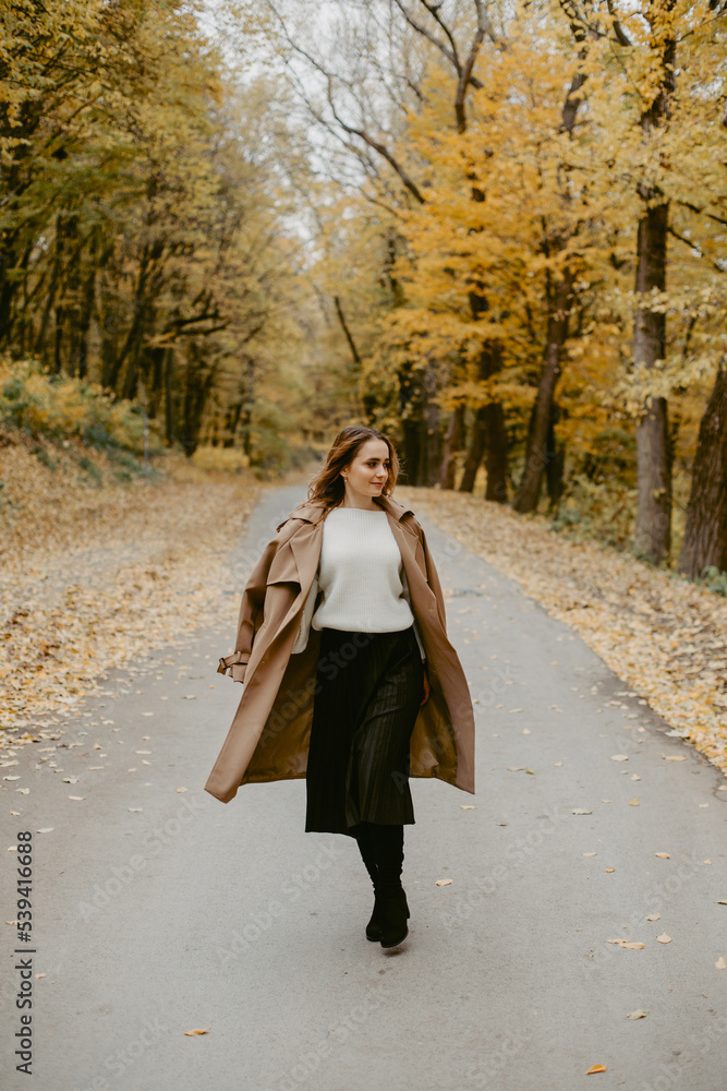 Woman walking in the autumn park, a healthy lifestyle, walk, exercise Woman walking in the autumn park, a healthy lifestyle, walk, exercise