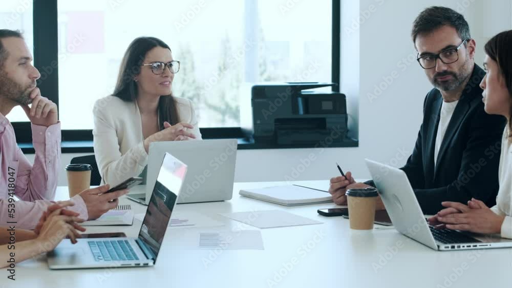 Video of  business people discussing together in conference room during meeting at office in a modern startup.