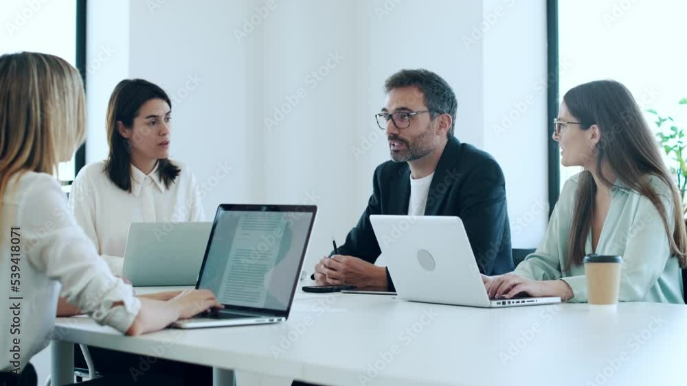 Video of business people discussing together in conference room during meeting at office in a modern startup. Video of business people discussing together in conference room during meeting at office in a modern startup.