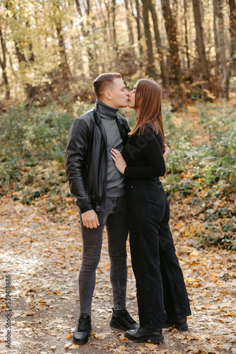 Lovely couple posing in autumn forest, lovers walking in park. lovestory in forest