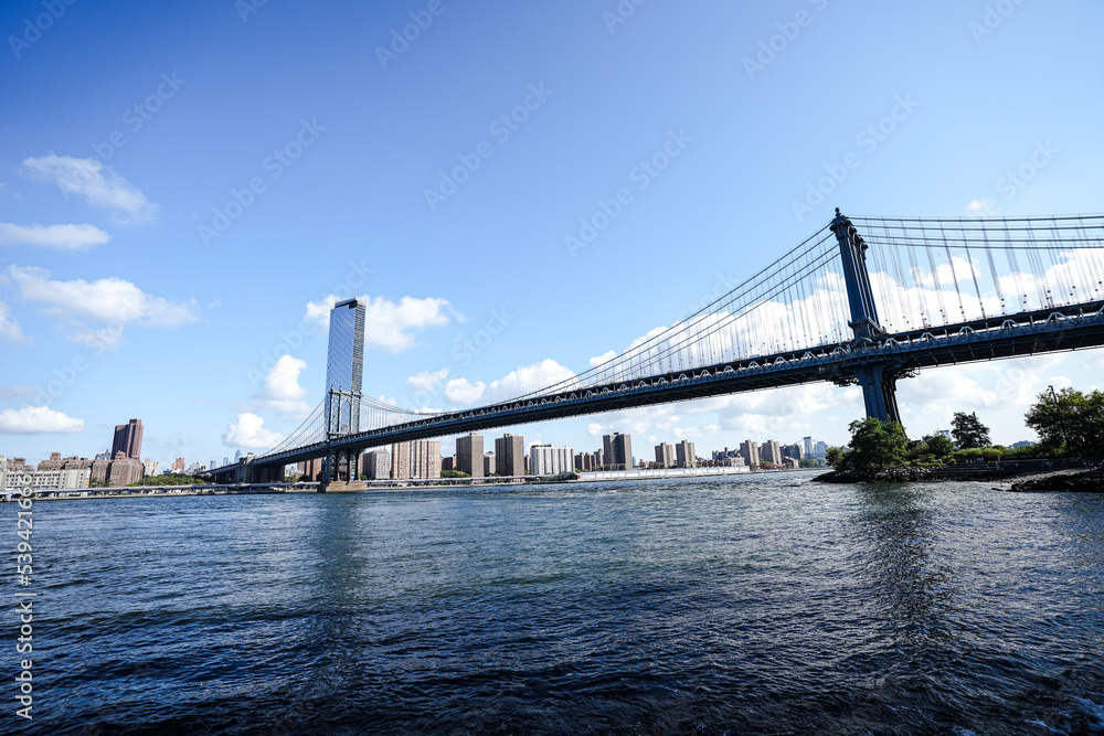 New York City, New York USA - September 2022. Manhattan bridge. Iron bridge view. Historic New York place. Brick wall buildings. Brownstone building.