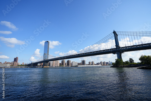 New York City, New York USA - September 2022. Manhattan bridge. Iron bridge view. Historic New York place. Brick wall buildings. Brownstone building.
