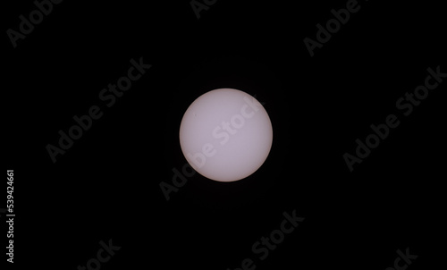 Sun with sunspots over clean black background