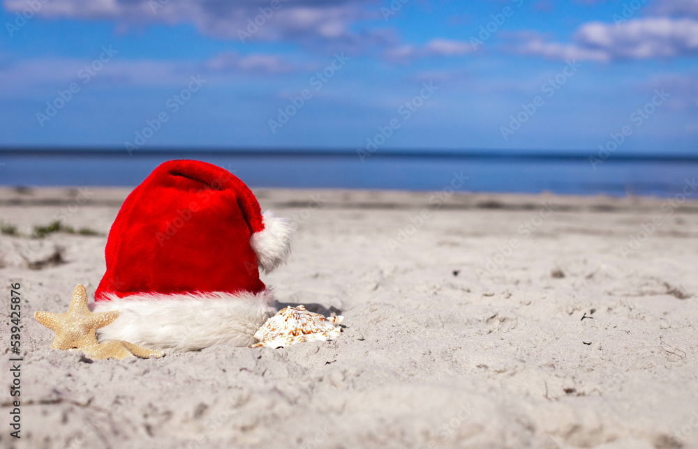 Santa Claus hat and starfish on the beach Santa Claus hat and starfish on the beach