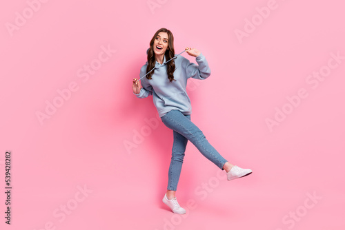 Full size portrait of overjoyed satisfied girl enjoy dancing clubbing hands play hoodie lace isolated on pink color background