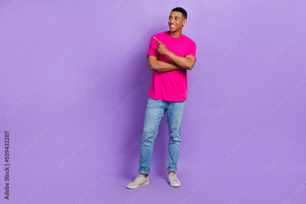 Full length photo of satisfied man stylish clothes arm direct look empty space present recommend shop isolated on purple color background Full length photo of satisfied man stylish clothes arm direct look empty space present recommend shop isolated on purple color background