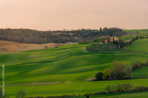 View of a farm upon the green hills of the Tuscany countryside, Italy
