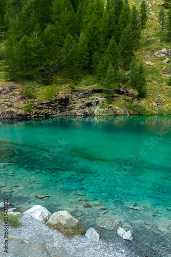 The crystal clear water of the Blue Lake of Ayes, Italian Alps