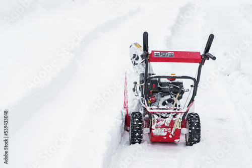 Russia Moscow 13.02.2021 Street snow blower. Self cleaning snow from road, sidewalk. Tractor, snow removal equipment. City winter weather collapse, snowfall, snowdrifts. Heavy snowstorm, blizzard