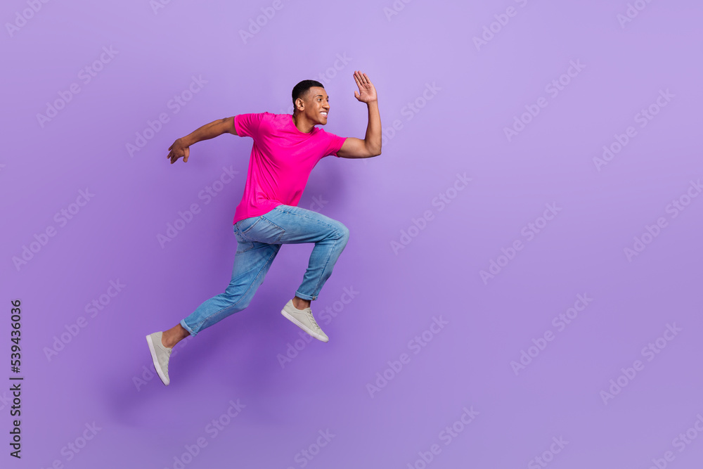 Full body profile portrait of active sporty man jumping run hurry empty space isolated on purple color background