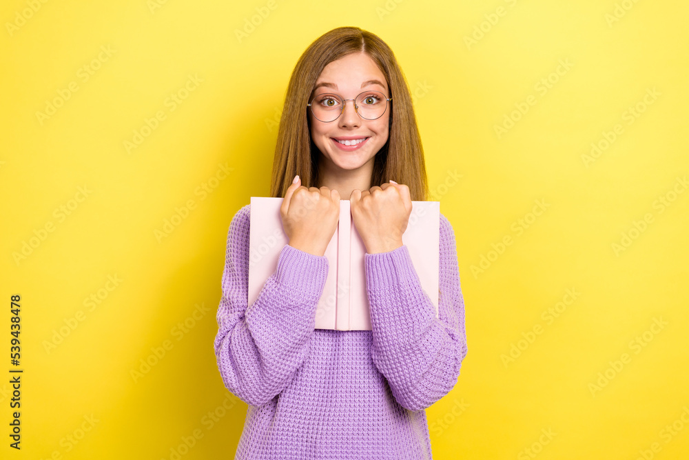 Photo of lovely lady schoolkid wear violet stylish sweater hold hug book textbook adore reading novel isolated on yellow color background Photo of lovely lady schoolkid wear violet stylish sweater hold hug book textbook adore reading novel isolated on yellow color background