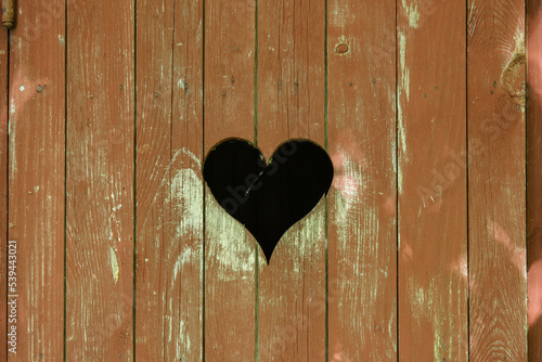 A heart carved in a wooden planks