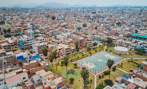 Aerial view of the football field in the middle of a messy neighborhood, Callao, Lima. Peru © rjankovsky