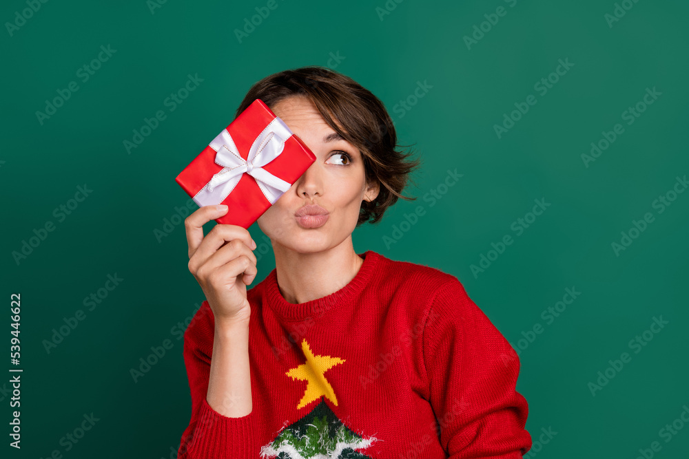 Photo of dreamy sweet lady wear red sweater bow package close eye looking empty space isolated green color background Photo of dreamy sweet lady wear red sweater bow package close eye looking empty space isolated green color background