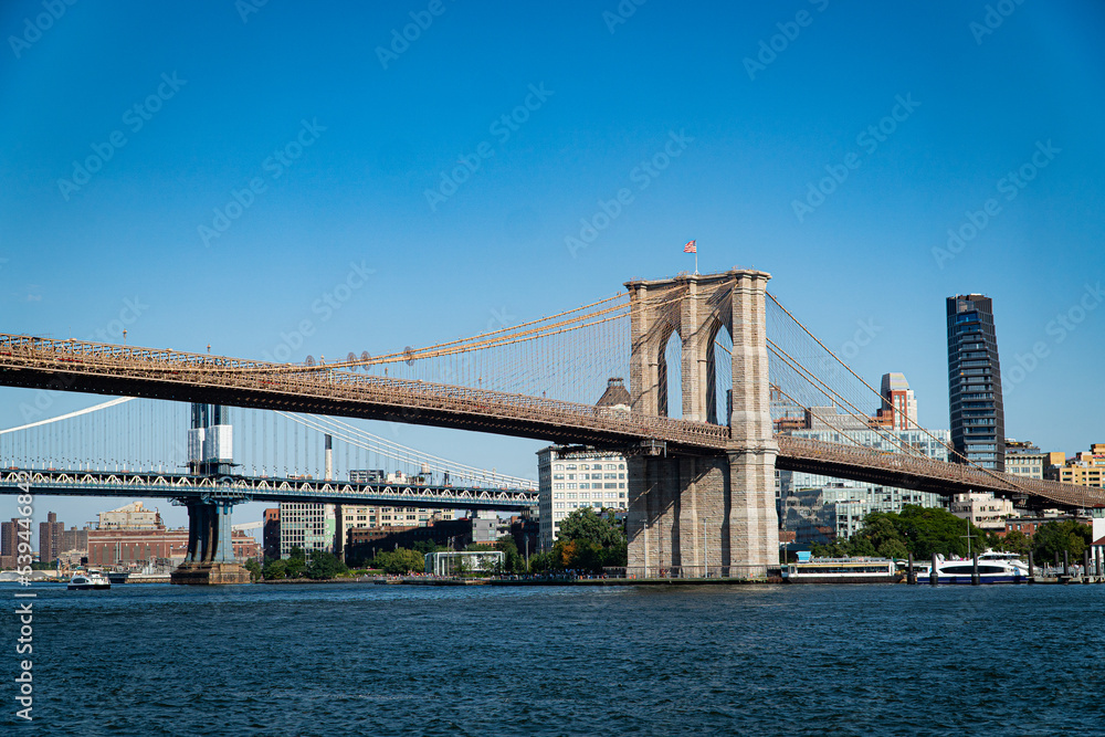 New York City, NY. USA - August 20, 2022: The Brooklyn Bridge seen from the Pier 17 at Manhattan