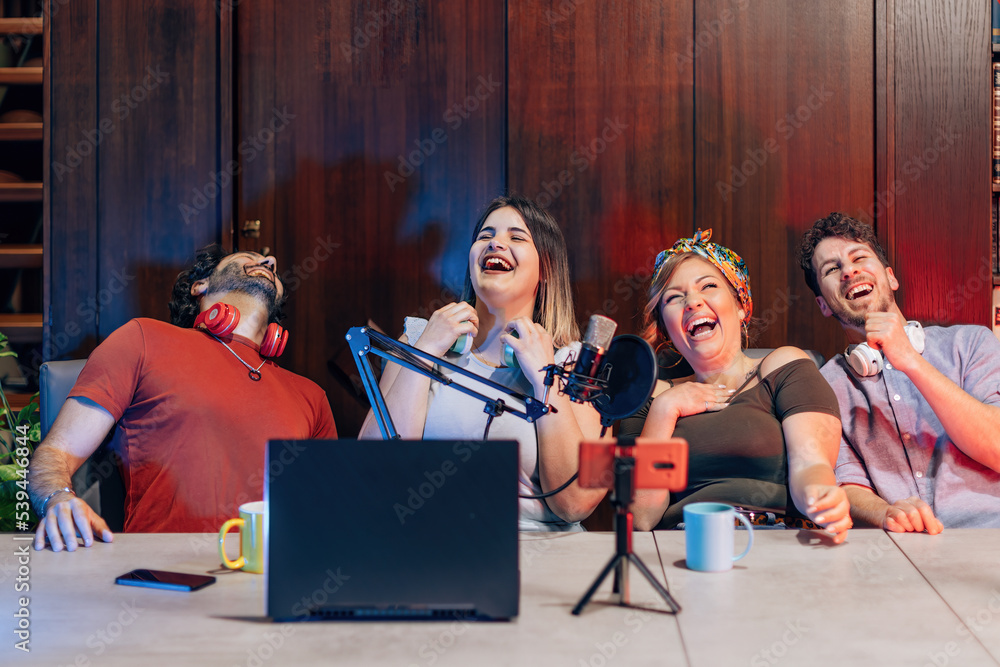 Fototapeta premium group of digital native friends laughs happy connected streaming on internet blogging channels