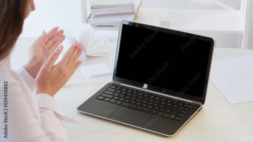 Successful online cooperation. Video call. Good job. Unrecognizable proud business woman applauding at blank notebook with mockup copy space black display. Successful online cooperation. Video call. Good job. Unrecognizable proud business woman applauding at blank notebook with mockup copy space black display.
