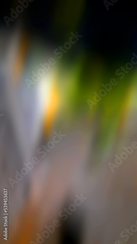 Abstract blurred background with a predominance of gray, there is also a little green and orange. © Mas Azhar