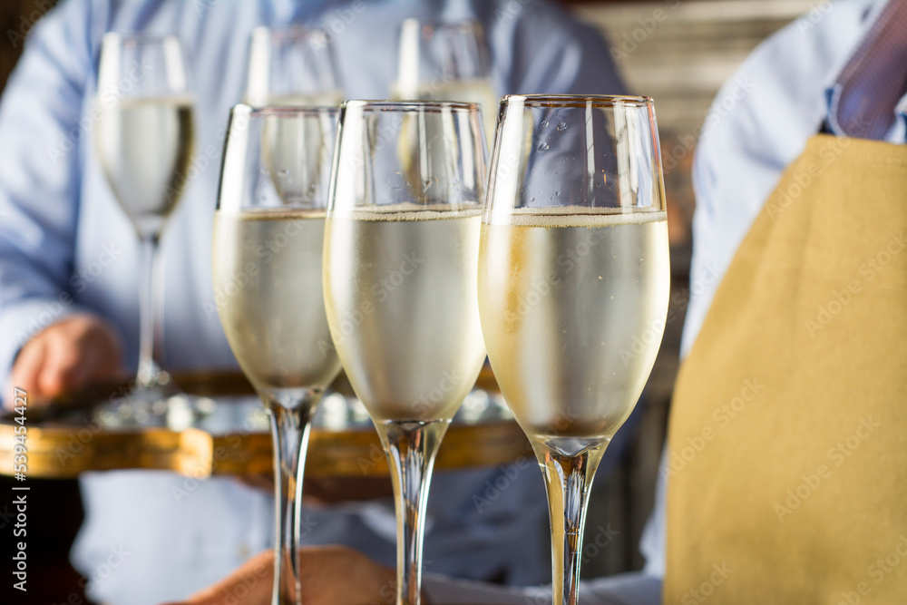 glasses of champagne served by waiter