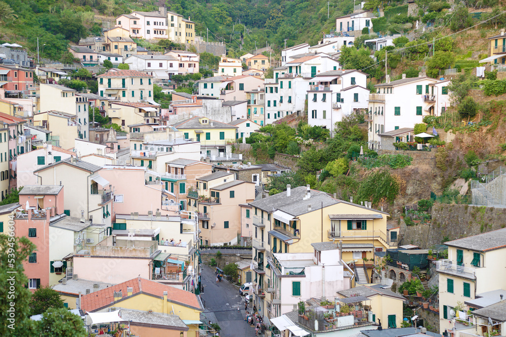 View of the colorful houses along the coastline of Cinque Terre area in Riomaggiore, Italy