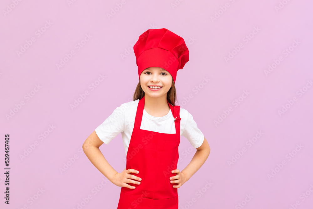 A very joyful girl in a chef's costume smiles, a girl in a chef's hat on an isolated background. A very joyful girl in a chef's costume smiles, a girl in a chef's hat on an isolated background.